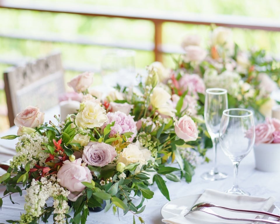 Beautiful flowers arranged in the middle of the dining table