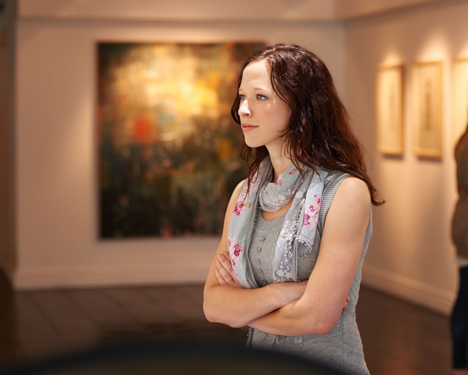 Shot of a young woman looking at paintings in a gallery