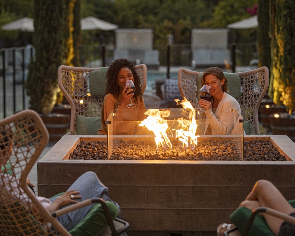 Girls at firepit on upper pool deck