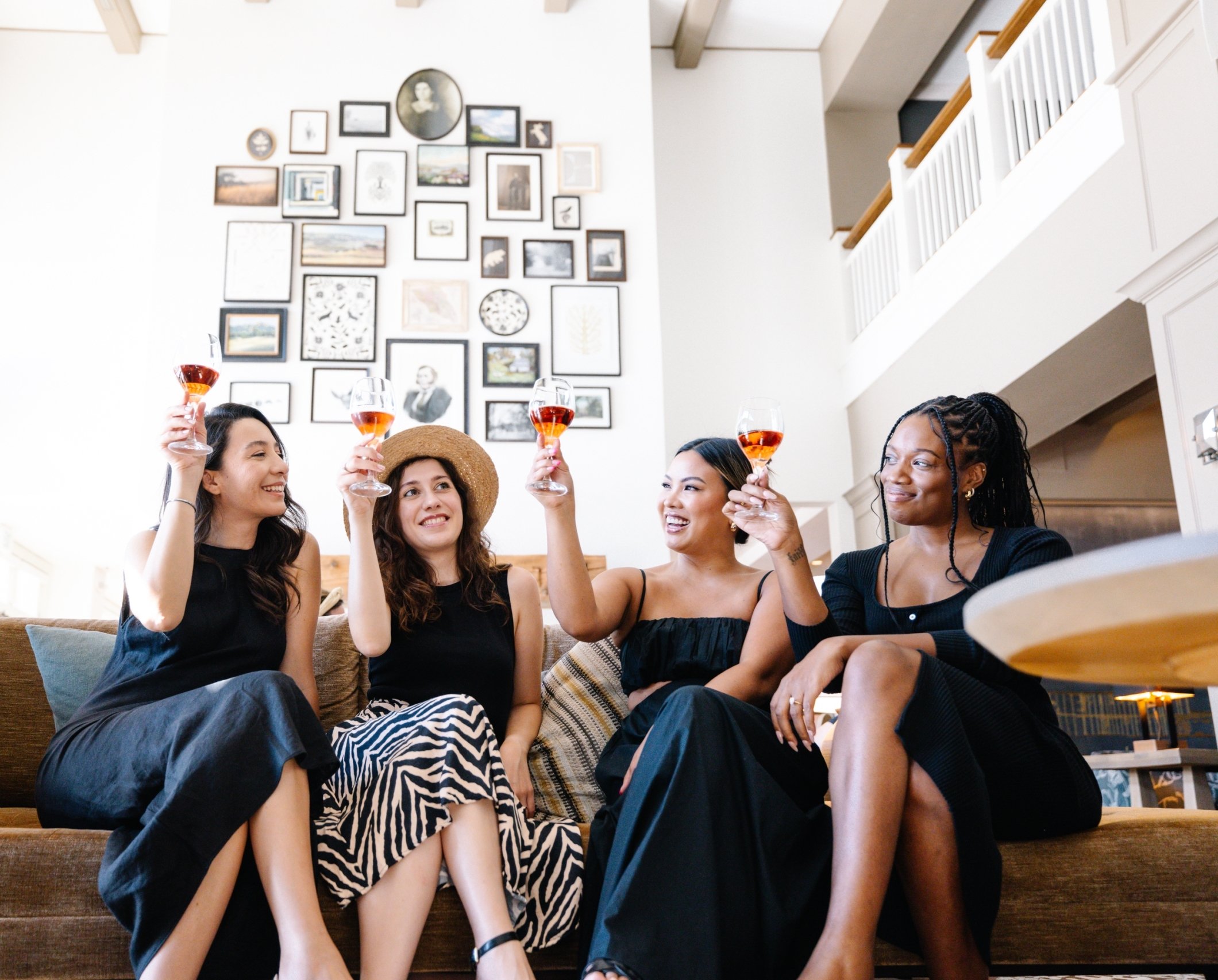 Four women toasting on couch