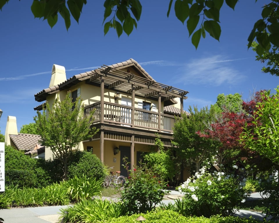 The Mediterranean-style cottage building at The Lodge at Sonoma with a bicycle parked near the entrance