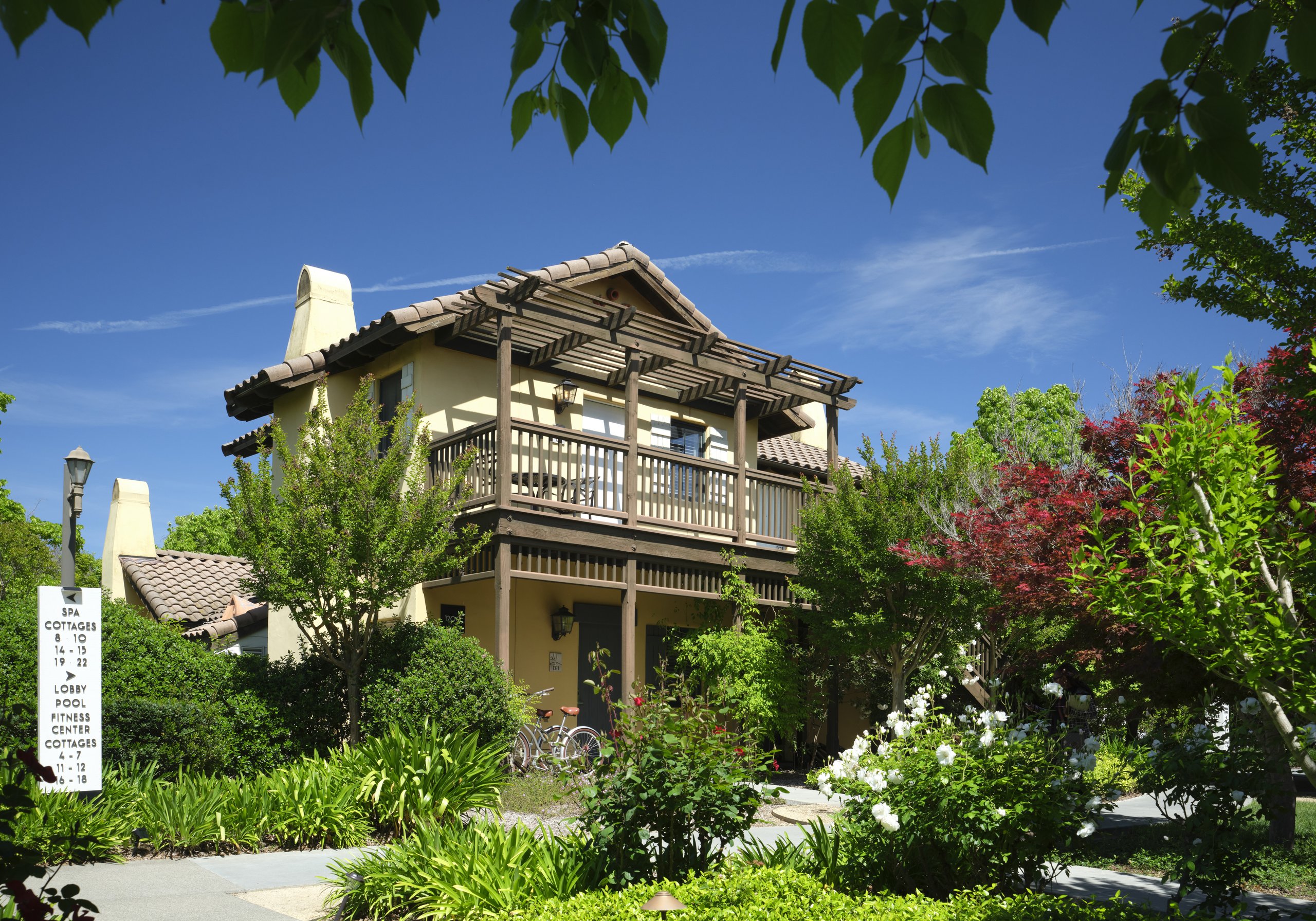 The Mediterranean-style cottage building at The Lodge at Sonoma with a bicycle parked near the entrance