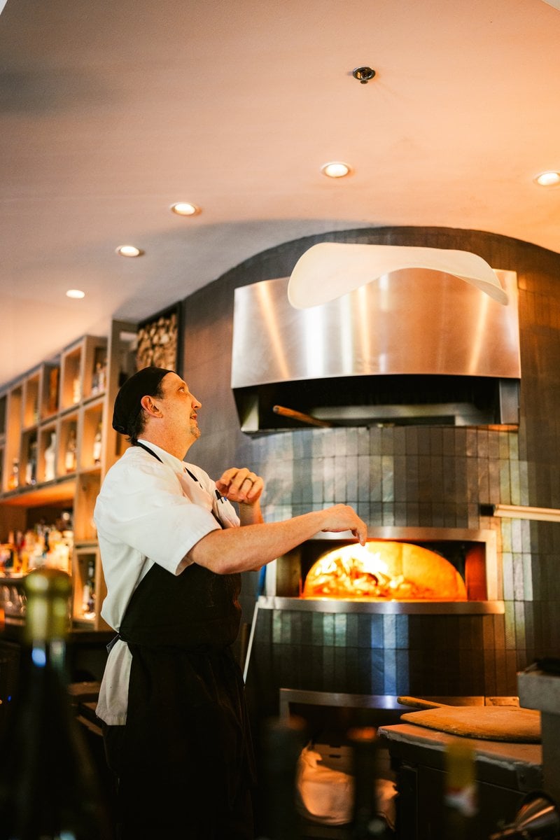 Hearth oven fire glowing in the Wit & Wisdom kitchen